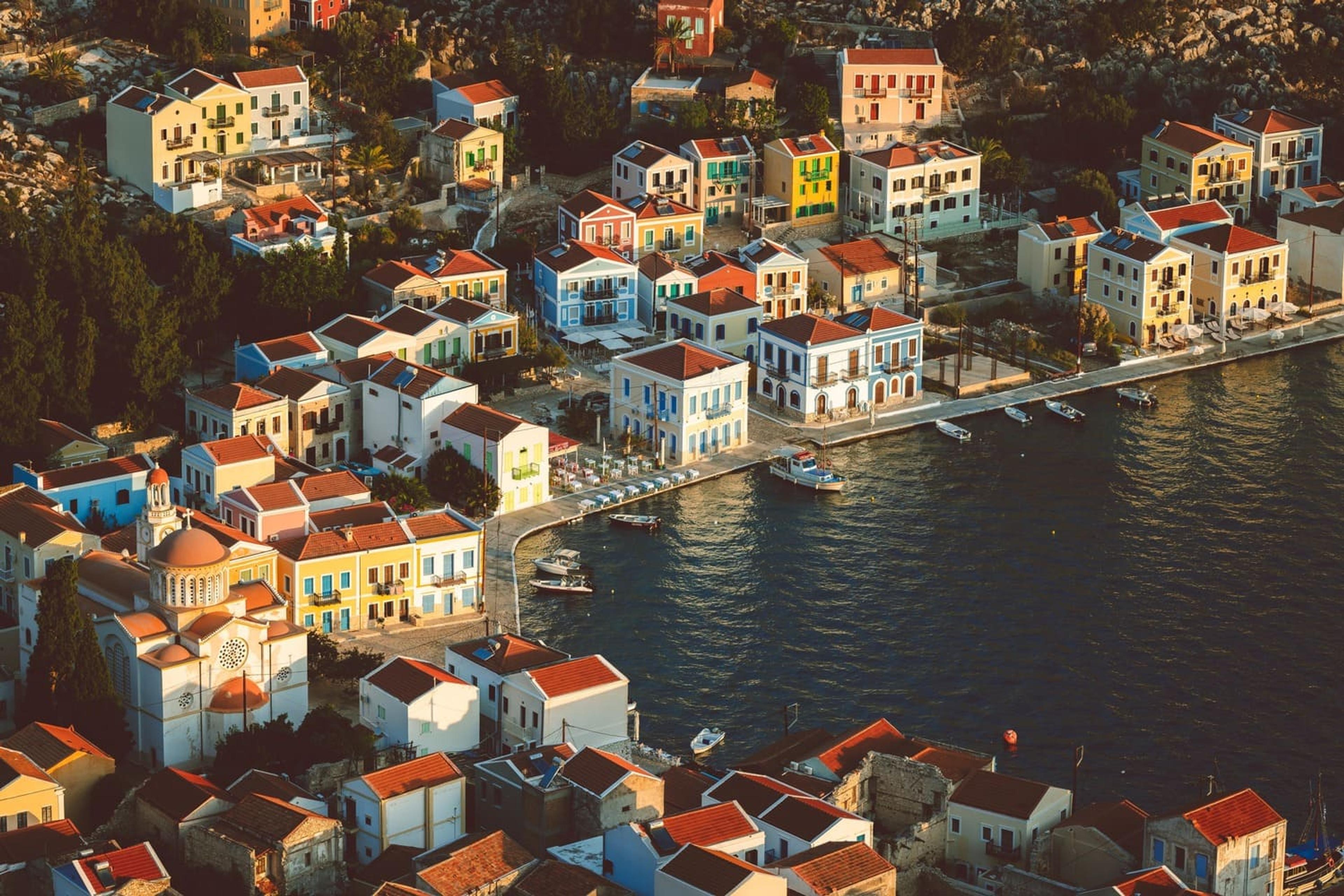 Aerial view of the colourful houses lining Meis harbour